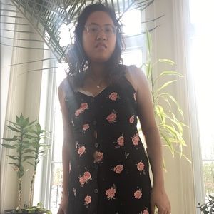 It is a black button maxi dress with pink roses